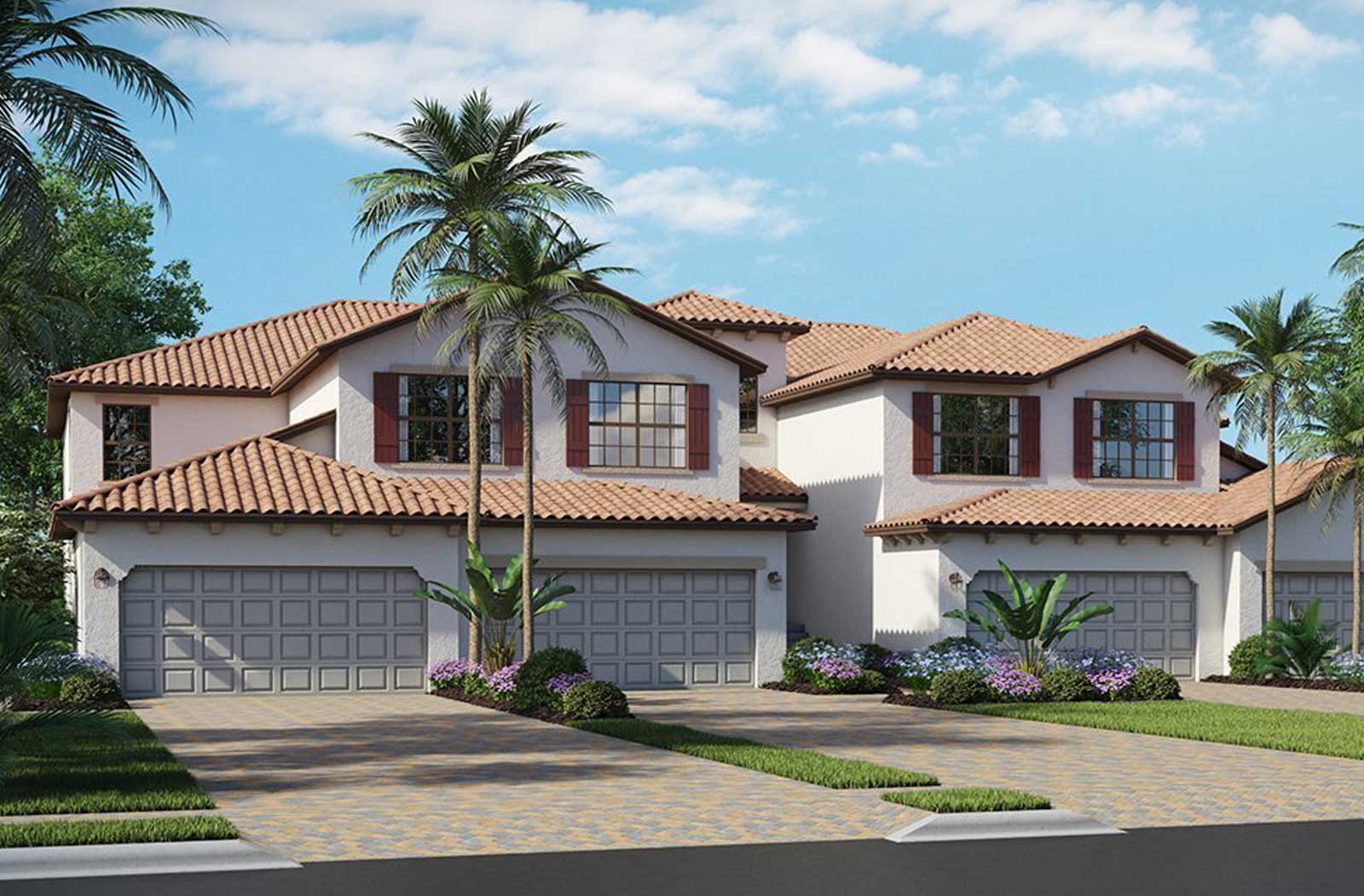 Mediterranean-style two-story townhomes with red tile roofs, gray garage doors, tropical landscaping, and palm trees under a clear blue sky.