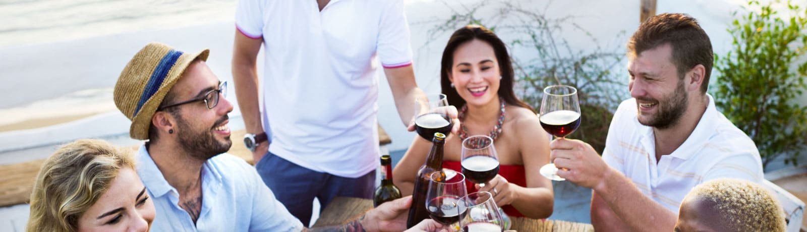 a group of people toasting wine glasses on a bench