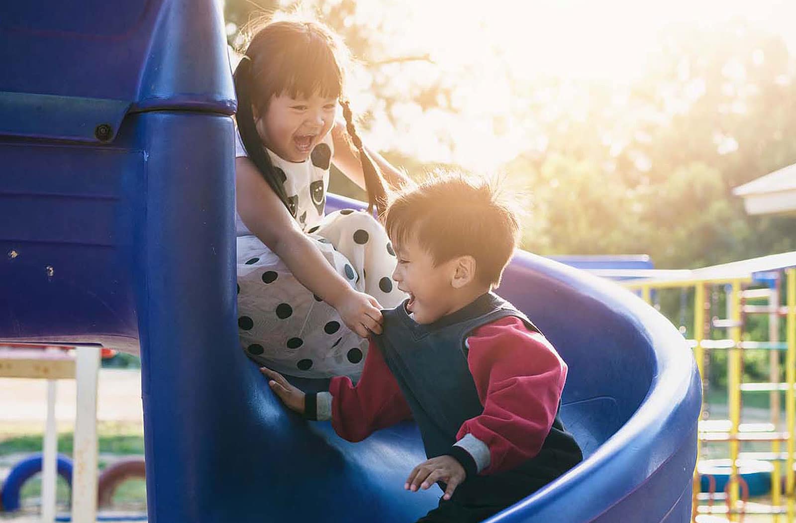 kids sliding down slide