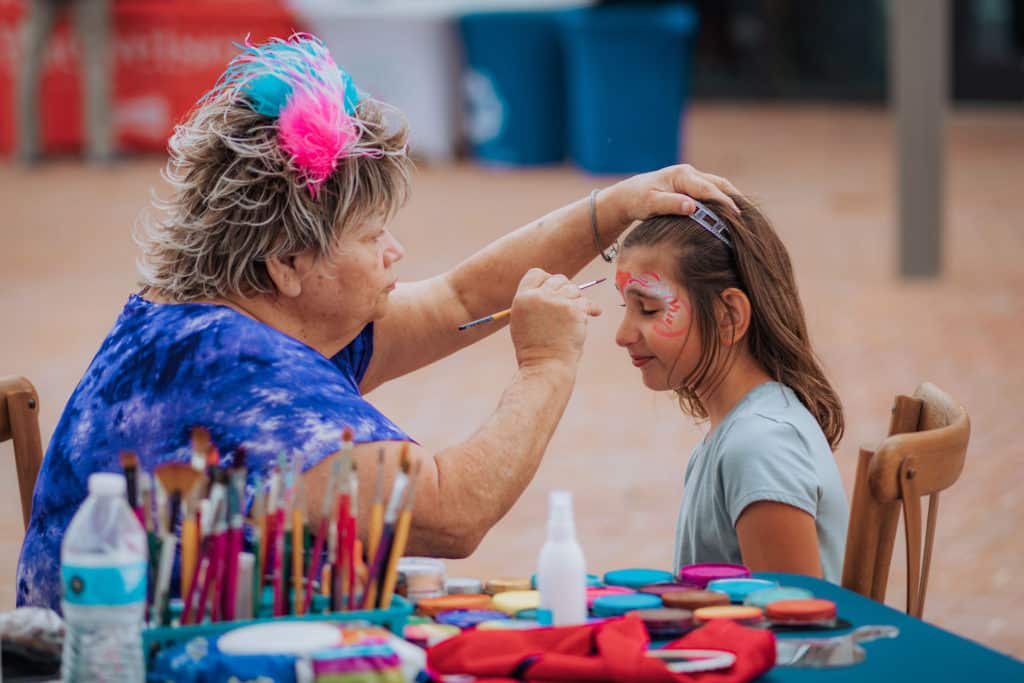 Person painting child's face
