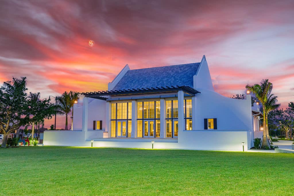 Solis Hall at dust with a green mowed lawn out front