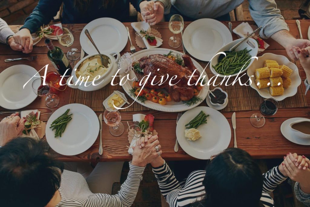 High angle shot of people sitting at a dining table with a text overlay