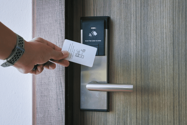 Hotel key opening a hotel room door