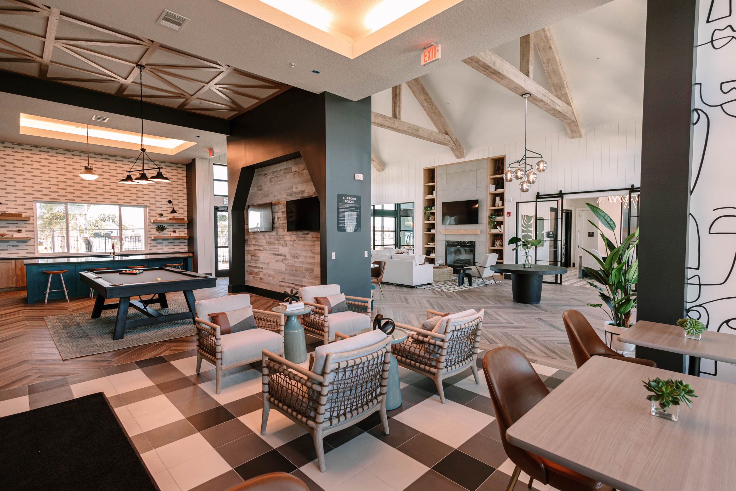 An amenity lounge space with games and dining tables for two