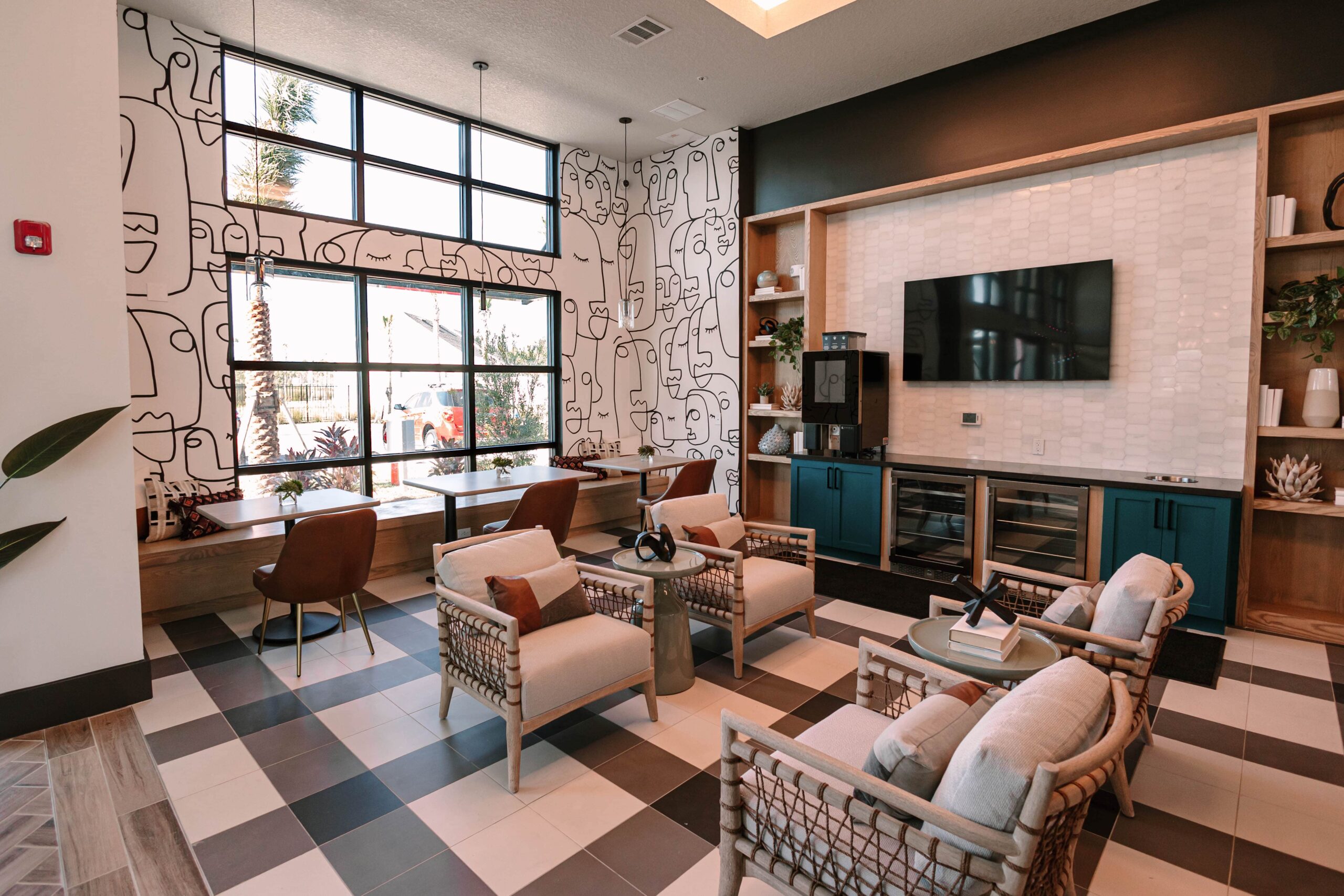 A Stillwell amenity lounge space, with a tv, chairs and work desks