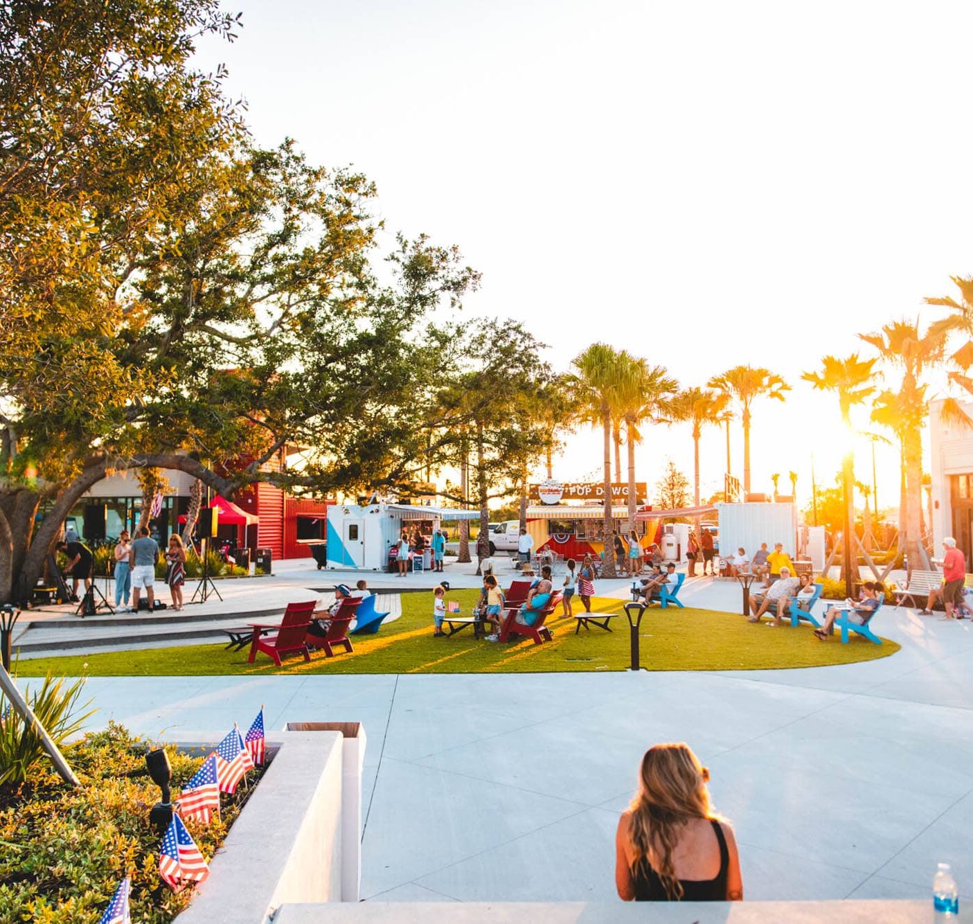 An outdoor park with paved walkways and neat grass areas with several benches at the center of Downtown Wellen