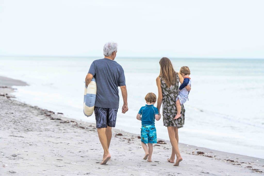 A family is walking on a beach near Wellen Park, FL.