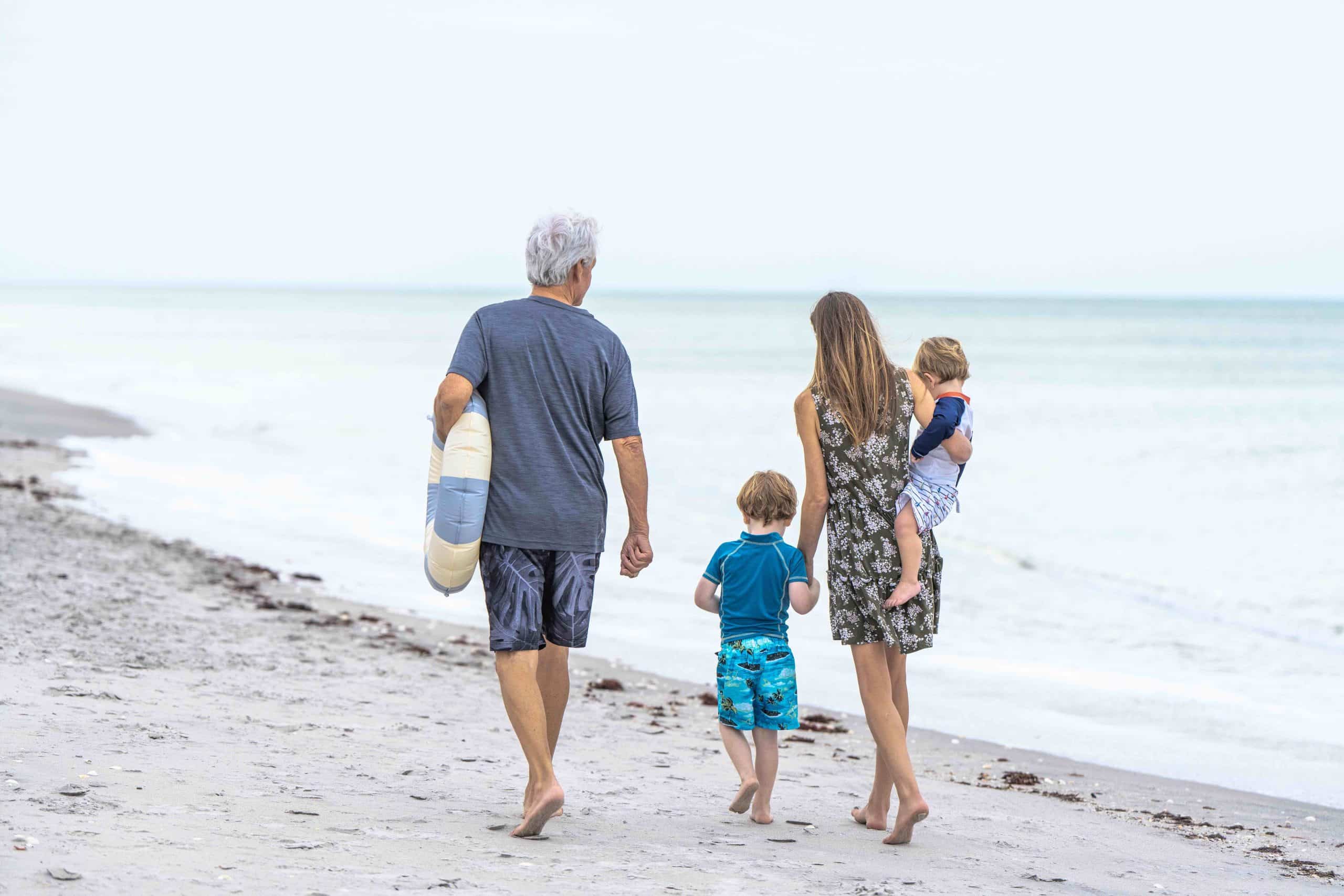 A family of four walking on a beach near Wellen Park, FL.